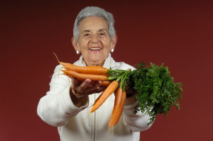 senior woman with carrots